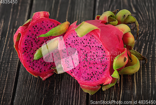 Image of Two halves of dragon fruit on planks