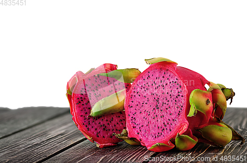 Image of Two halves of dragon fruit on planks