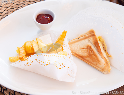 Image of French fries and sandwiches on a plate