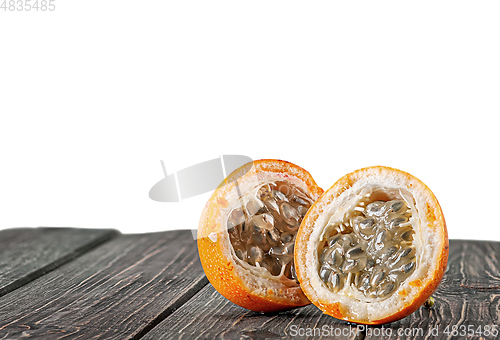 Image of Two halves of tamarillo on wooden table