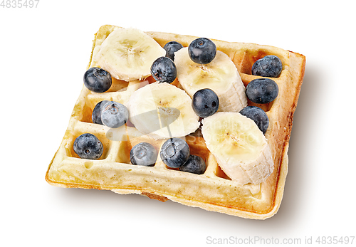 Image of French waffles with blueberries and bananas top wiev