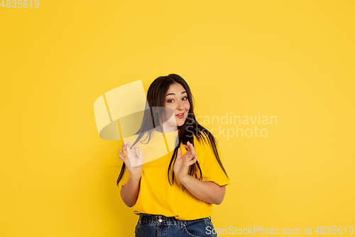 Image of Caucasian woman\'s portrait isolated on yellow studio background