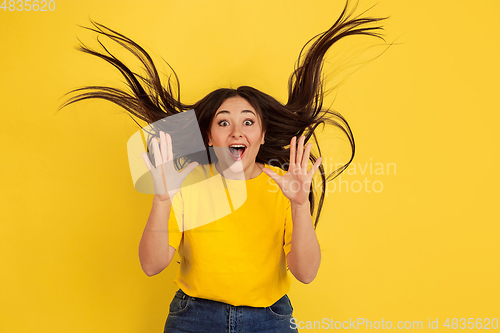 Image of Caucasian woman\'s portrait isolated on yellow studio background