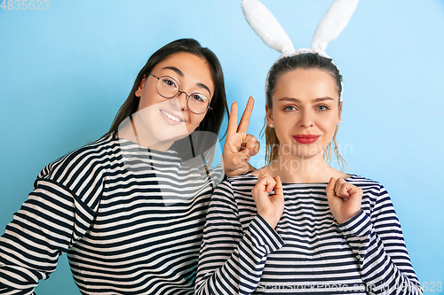 Image of Young emotional women on gradient blue background