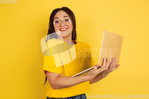Image of Caucasian woman\'s portrait isolated on yellow studio background