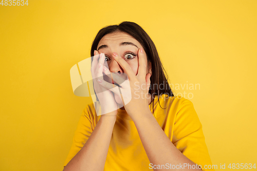 Image of Caucasian woman\'s portrait isolated on yellow studio background
