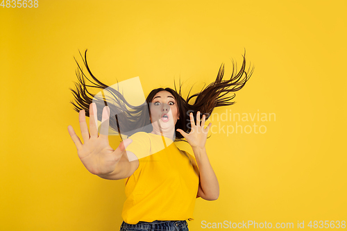 Image of Caucasian woman\'s portrait isolated on yellow studio background