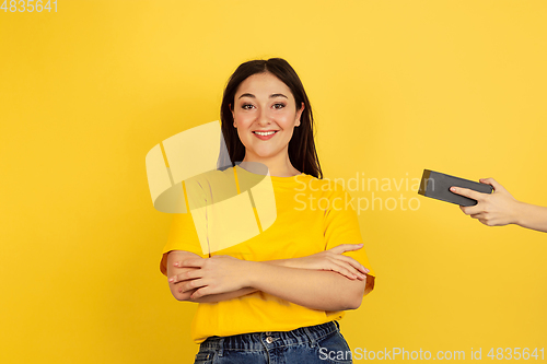 Image of Caucasian woman\'s portrait isolated on yellow studio background