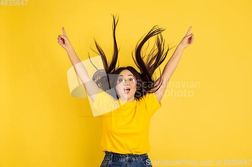 Image of Caucasian woman\'s portrait isolated on yellow studio background