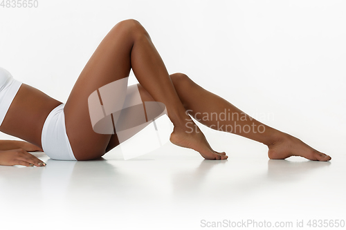 Image of Slim tanned woman\'s body isolated on white studio background