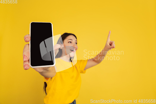 Image of Caucasian woman\'s portrait isolated on yellow studio background