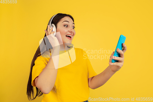 Image of Caucasian woman\'s portrait isolated on yellow studio background