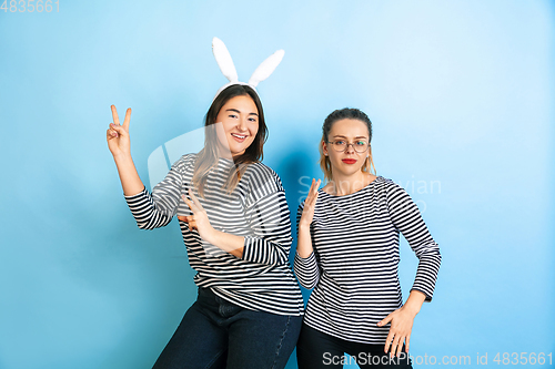 Image of Young emotional women on gradient blue background