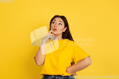 Image of Caucasian woman\'s portrait isolated on yellow studio background