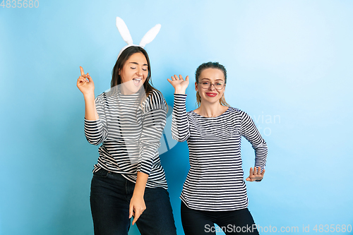 Image of Young emotional women on gradient blue background