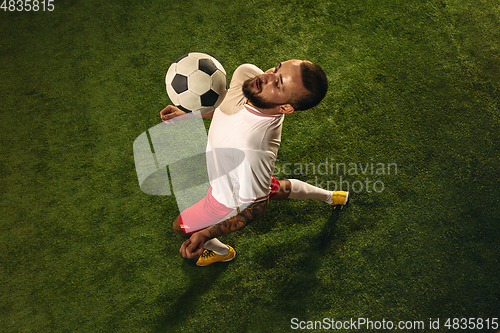 Image of Top view of caucasian football or soccer player on green background of grass