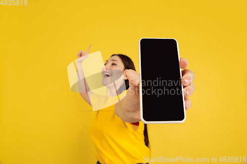 Image of Caucasian woman\'s portrait isolated on yellow studio background