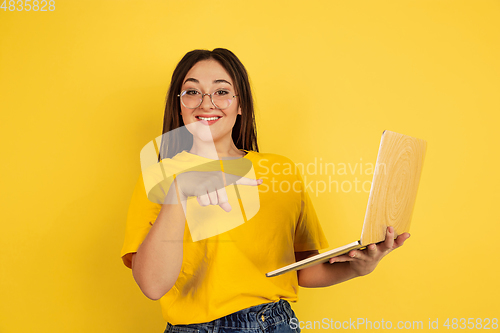 Image of Caucasian woman\'s portrait isolated on yellow studio background
