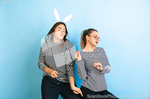 Image of Young emotional women on gradient blue background