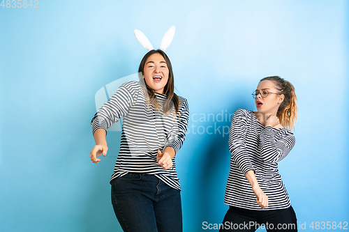 Image of Young emotional women on gradient blue background