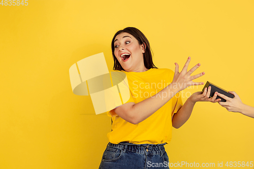 Image of Caucasian woman\'s portrait isolated on yellow studio background