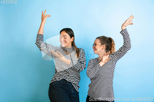 Image of Young emotional women on gradient blue background