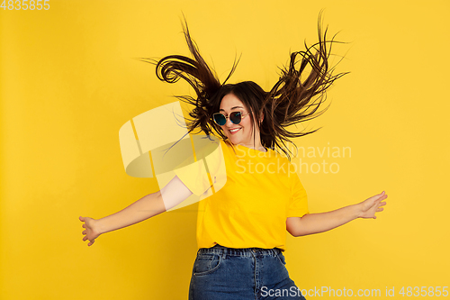 Image of Caucasian woman\'s portrait isolated on yellow studio background