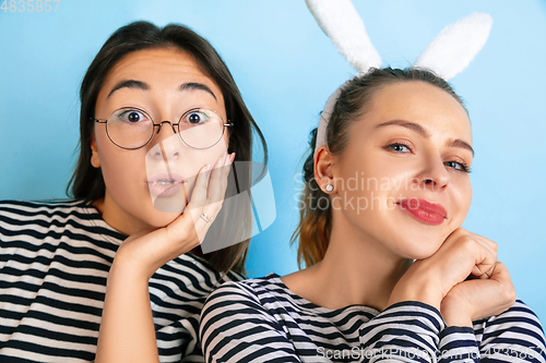 Image of Young emotional women on gradient blue background