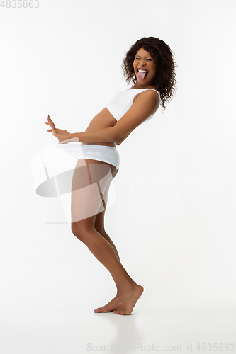 Image of Slim tanned woman\'s body isolated on white studio background