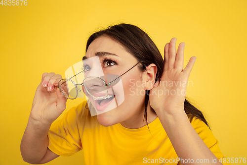 Image of Caucasian woman\'s portrait isolated on yellow studio background