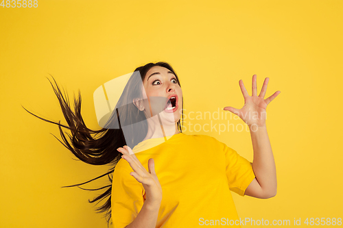 Image of Caucasian woman\'s portrait isolated on yellow studio background