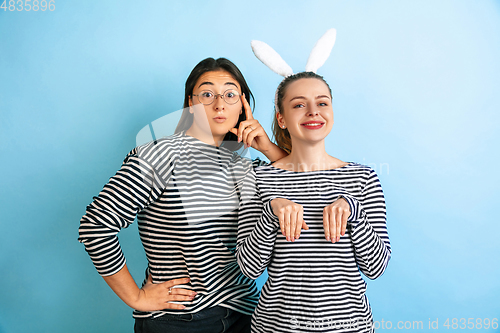 Image of Young emotional women on gradient blue background