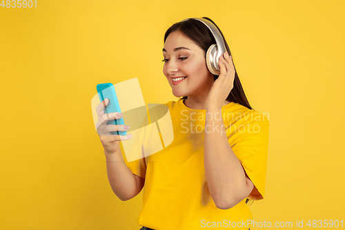 Image of Caucasian woman\'s portrait isolated on yellow studio background