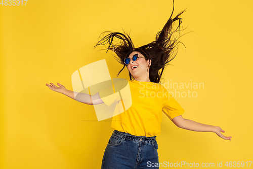 Image of Caucasian woman\'s portrait isolated on yellow studio background