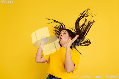 Image of Caucasian woman\'s portrait isolated on yellow studio background