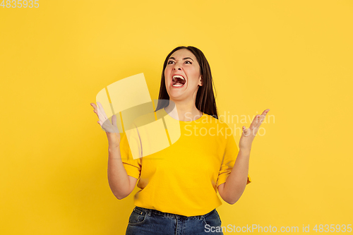 Image of Caucasian woman\'s portrait isolated on yellow studio background