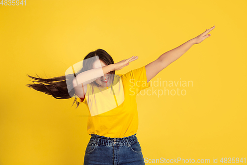 Image of Caucasian woman\'s portrait isolated on yellow studio background