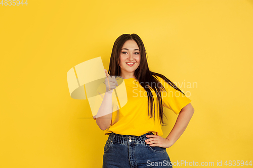 Image of Caucasian woman\'s portrait isolated on yellow studio background