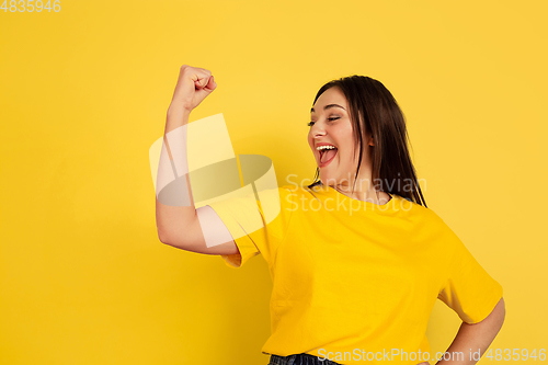 Image of Caucasian woman\'s portrait isolated on yellow studio background