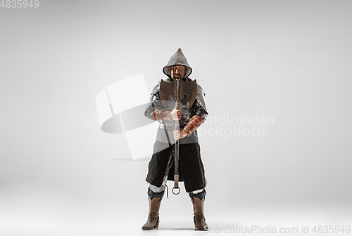 Image of Brave armored knight fighting isolated on white studio background