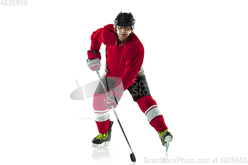 Image of Male hockey player with the stick on ice court and white background