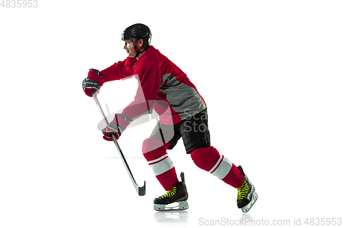 Image of Male hockey player with the stick on ice court and white background