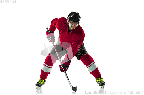 Image of Male hockey player with the stick on ice court and white background