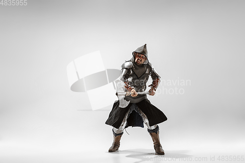 Image of Brave armored knight fighting isolated on white studio background