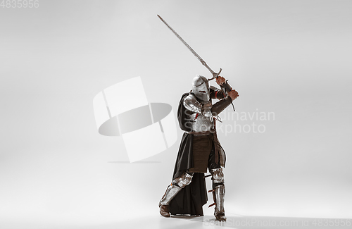 Image of Brave armored knight fighting isolated on white studio background