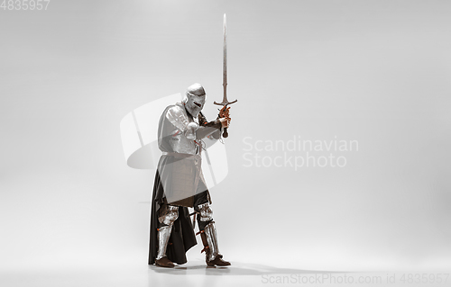 Image of Brave armored knight fighting isolated on white studio background