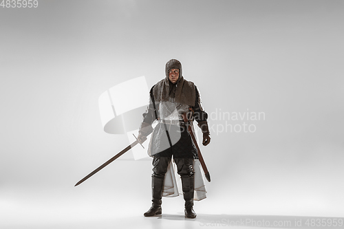 Image of Brave armored knight fighting isolated on white studio background