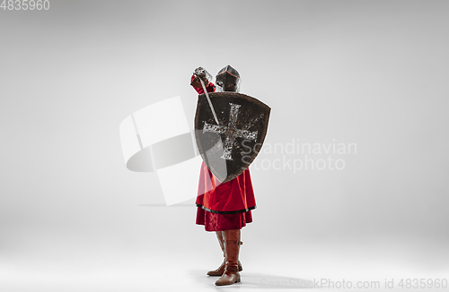 Image of Brave armored knight fighting isolated on white studio background