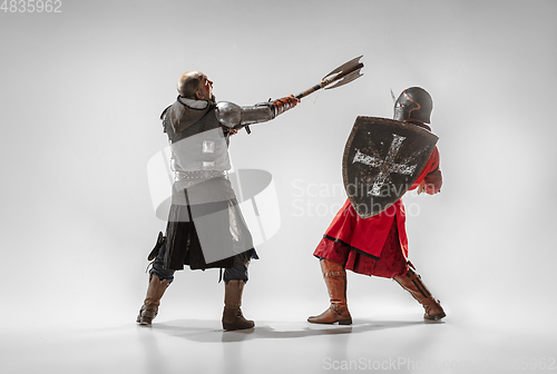 Image of Brave armored knights fighting isolated on white studio background