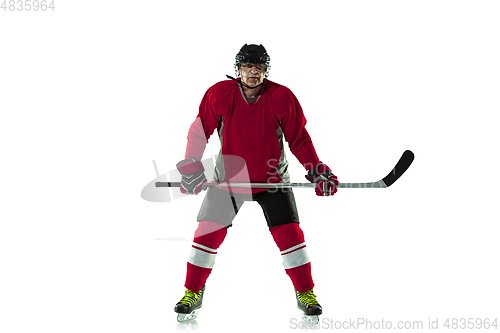 Image of Male hockey player with the stick on ice court and white background